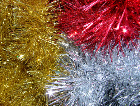 three colours of tinsel that makes a sparkly christmas backgroundの写真素材