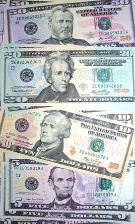 A pile of crisp new american dollars of various values