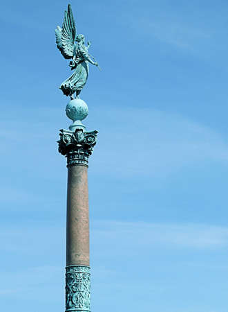 view of an angel statue atop a stone column in the danish capitol of copenhagenの写真素材