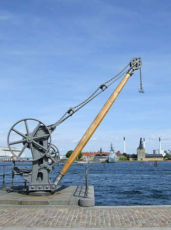 A piece of old industrial machinery on the banks of a canal in copenhagenの写真素材