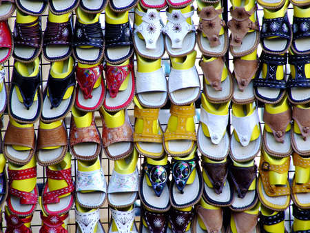 A close up of a wall of flip flops on a market stallの写真素材