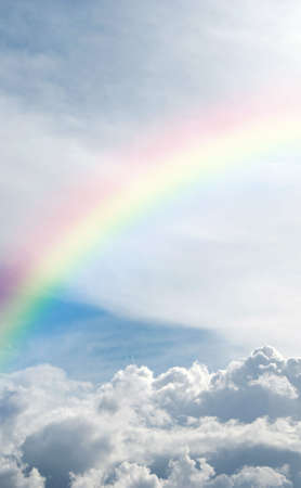 A heavenly rainbow set against a beautiful cloudscape.の写真素材