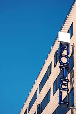 An unlit neon hotel sign situated next to the room windowsの写真素材