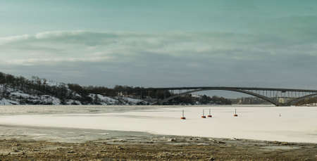 A view of a bridge in Stockholm, Sweden from a frozen mass of water at winter.の写真素材