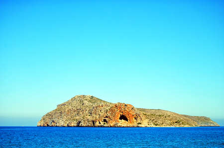 The small island of Theodori Nisida as seen from the greek island of Crete.の写真素材