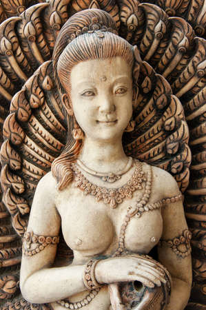 A buddhist carving typical of the sort that adorns the outside of homes or shops in Thailand.の写真素材