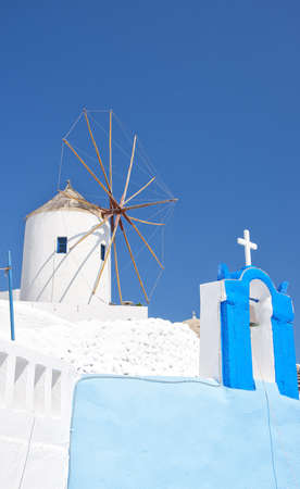One of the traditional windmills of Oia on the greek paradise island of Santorini.の写真素材