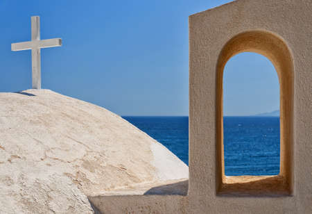 A close up view of one of the many churches that adorn the greek island of santorini.の写真素材