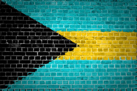 An image of the bahamas flag painted on a brick wall in an urban locationの写真素材