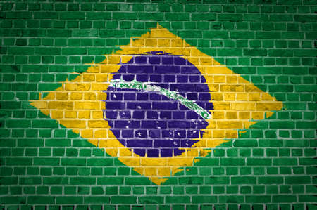 An image of the Brazil flag painted on a brick wall in an urban locationの写真素材