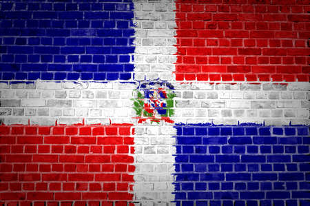 An image of the Dominican Republic flag painted on a brick wall in an urban locationの写真素材