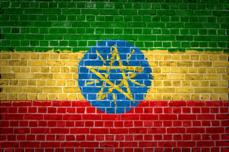 An image of the Ethiopia flag painted on a brick wall in an urban locationの写真素材