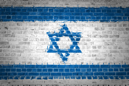 An image of the Israel flag painted on a brick wall in an urban locationの写真素材
