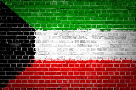An image of the Kuwait flag painted on a brick wall in an urban locationの写真素材
