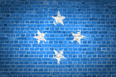 An image of the Micronesia flag painted on a brick wall in an urban locationの写真素材