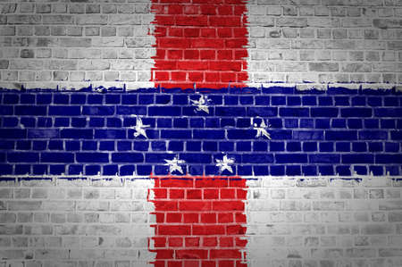 An image of the Netherlands Antilles flag painted on a brick wall in an urban locationの写真素材