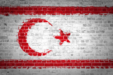 An image of the Northern Cyprus flag painted on a brick wall in an urban locationの写真素材