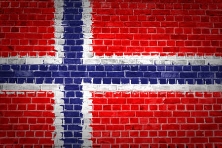 An image of the Norway flag painted on a brick wall in an urban locationの写真素材