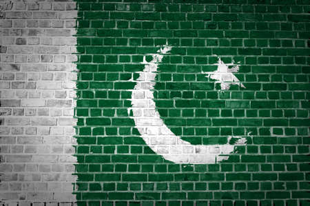 An image of the Pakistan flag painted on a brick wall in an urban locationの写真素材