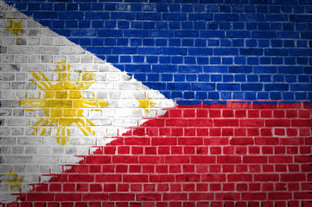 An image of the Philippines flag painted on a brick wall in an urban locationの写真素材