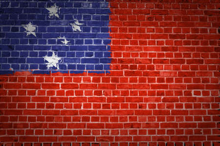 An image of the Samoa flag painted on a brick wall in an urban locationの写真素材