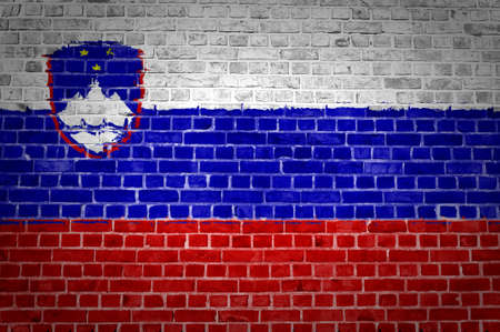An image of the Slovenia flag painted on a brick wall in an urban locationの写真素材
