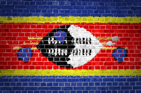 An image of the Swaziland flag painted on a brick wall in an urban locationの写真素材