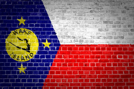 An image of the Wake Island flag painted on a brick wall in an urban locationの写真素材