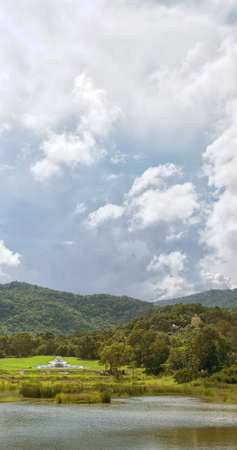 A large golden buddha sits on a hillside overlooking the area of Hua Hin in Thailand.