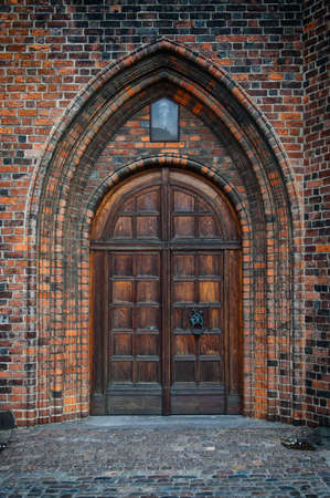 An arched doorway to a gothic style church.の写真素材