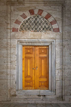 Old ornate wooden doors at the Beyazit Camii mosque in istanbul, Turkey.の写真素材
