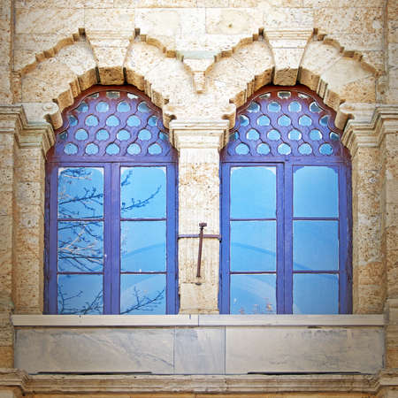 A pair of blue tinted windows from a mosque in the turkish city of Istanbul.の写真素材