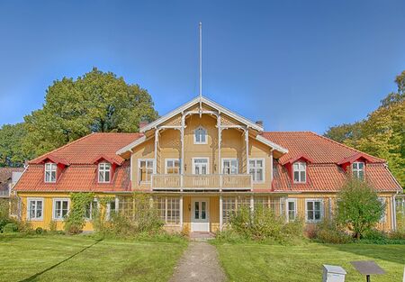 A yellow house situated at ramlosa brunnspark on the outskirts of Helsingborg in Sweden.のeditorial素材
