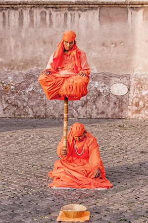 ROME, ITALY - JANUARY 08: Indian Fakirs performing levitation trick in Rome on January 08, 2014. In 2011 city council proposed to regulate street performers to remove many of them from Rome.のeditorial素材