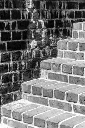 Bright brick steps against a dark brick wallの写真素材