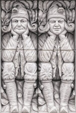 A couple of gargoyles carved into a building in the Swedish city of Lund.の写真素材