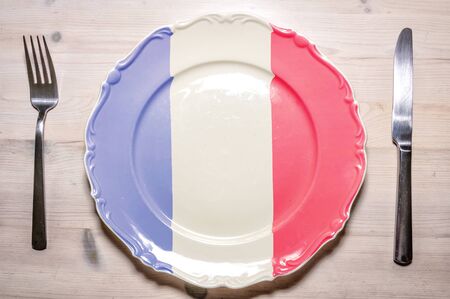 A flag concept of a dinner plate with the flag of France on it.の写真素材