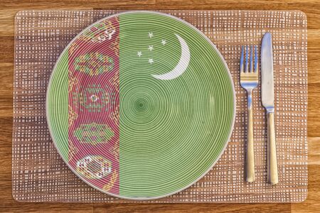 Dinner plate with the flag of Turkmenistan on it for your international food and drink concepts.の写真素材