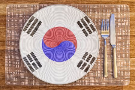 Dinner plate with the flag of South Korea on it for your international food and drink concepts.の写真素材