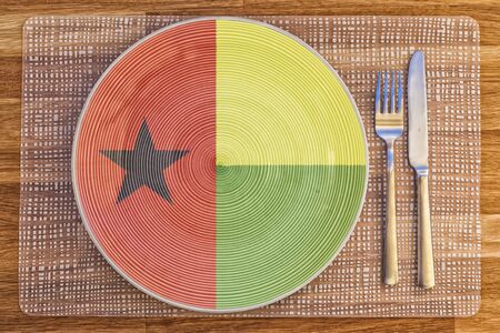 Dinner plate with the flag of Guinea Bissau on it for your international food and drink concepts.の写真素材