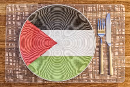 Dinner plate with the flag of Palestine on it for your international food and drink concepts.の写真素材