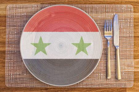 Dinner plate with the flag of Syria on it for your international food and drink concepts.の写真素材