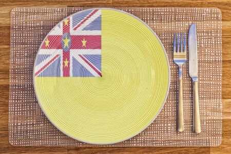 Dinner plate with the flag of Niue on it for your international food and drink concepts.の写真素材
