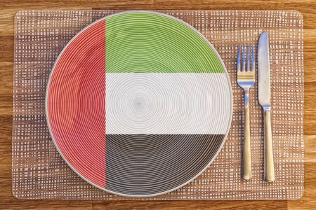 Dinner plate with the flag of the United Arab Emirates on it for your international food and drink concepts.の写真素材