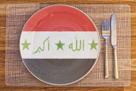 Dinner plate with the flag of Iraq on it for your international food and drink concepts.の写真素材