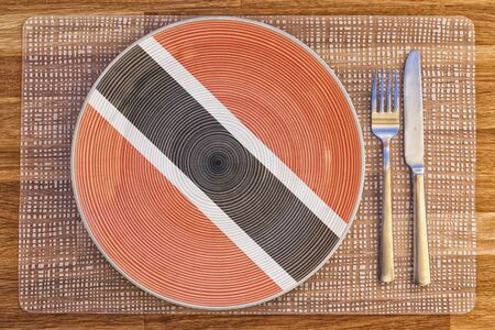 Dinner plate with the flag of Trinidad and Tobago on it for your international food and drink concepts.の写真素材