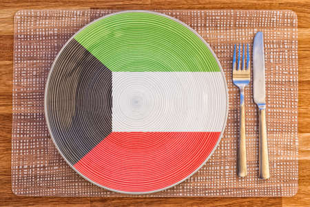 Dinner plate with the flag of Kuwait on it for your international food and drink concepts.の写真素材