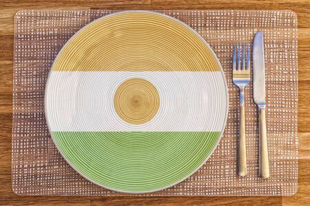 Dinner plate with the flag of Niger on it for your international food and drink concepts.の写真素材