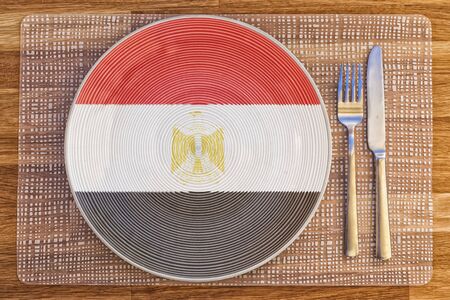 Dinner plate with the flag of Egypt on it for your international food and drink concepts.の写真素材