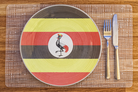 Dinner plate with the flag of Uganda on it for your international food and drink concepts.の写真素材